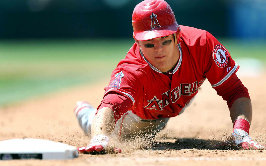 Mike Trout Slides Home: Powerful Action Shot in Angels Uniform Wallpaper