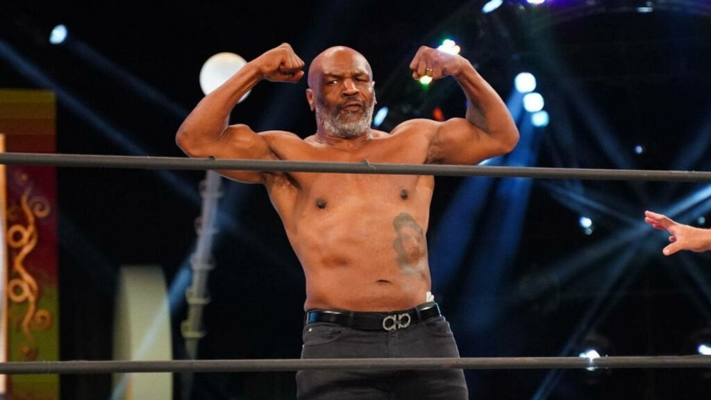 Iconic Mike Tyson Flexing Muscles: Powerful Wallpaper Background
