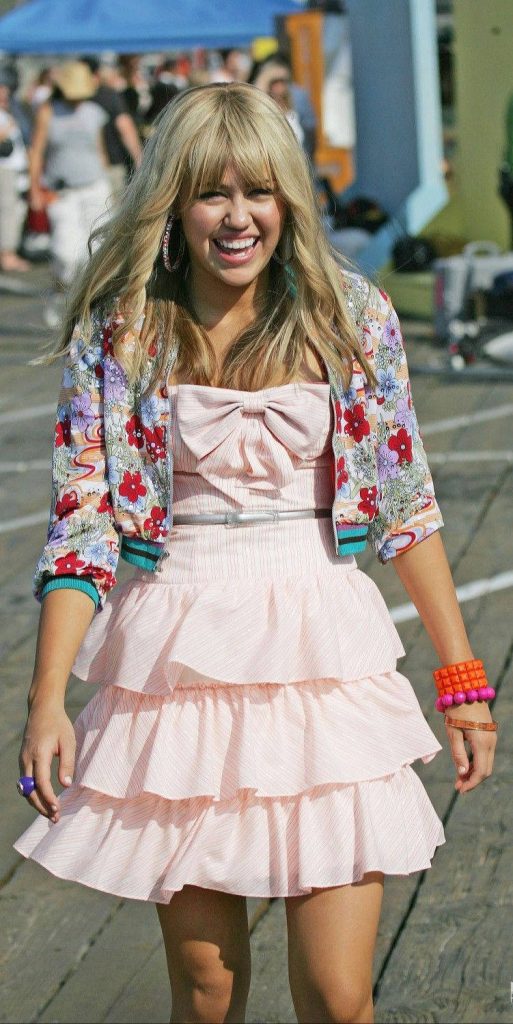 Miley Cyrus as Hannah Montana in pink ruffled dress and floral jacket 2000s wallpaper