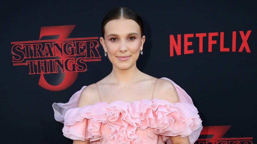 Millie Bobby Brown in pink ruffled dress at Stranger Things 3 Netflix premiere wallpaper background