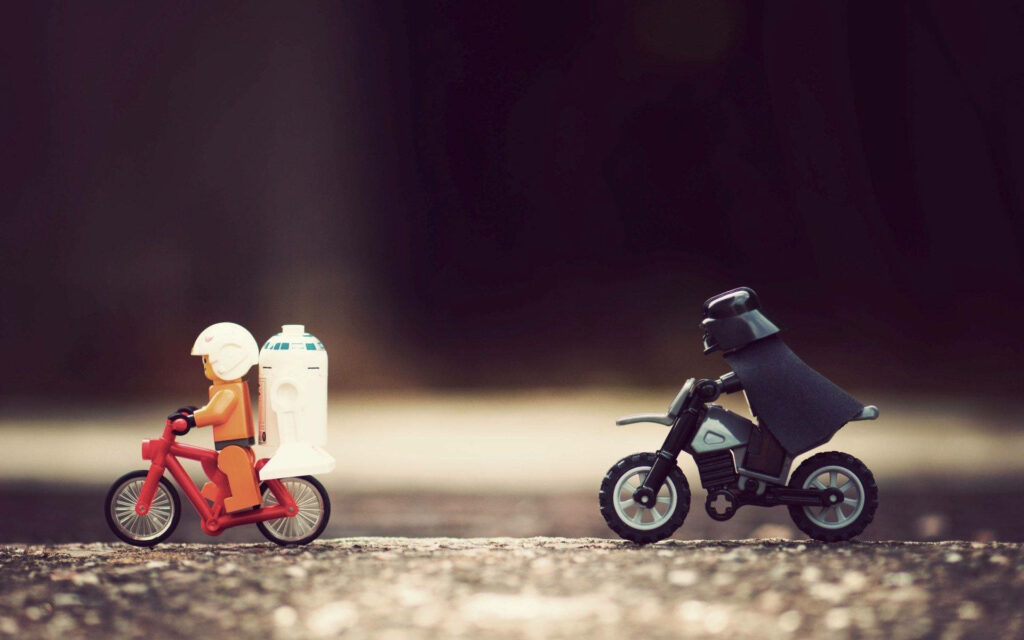 Adorable Star Wars Lego Characters Engage in an Epic High-Speed Pursuit on Blurred Background Wallpaper
