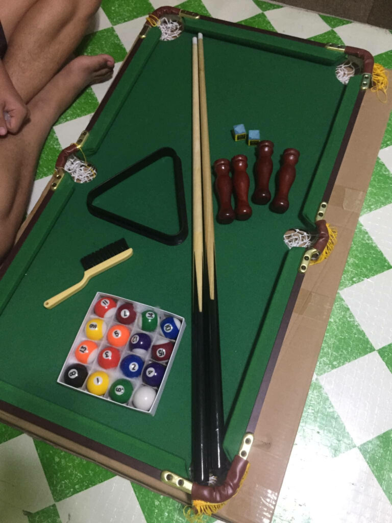 Miniature Pool Table with Green Felt - Playful Billiards Wallpaper