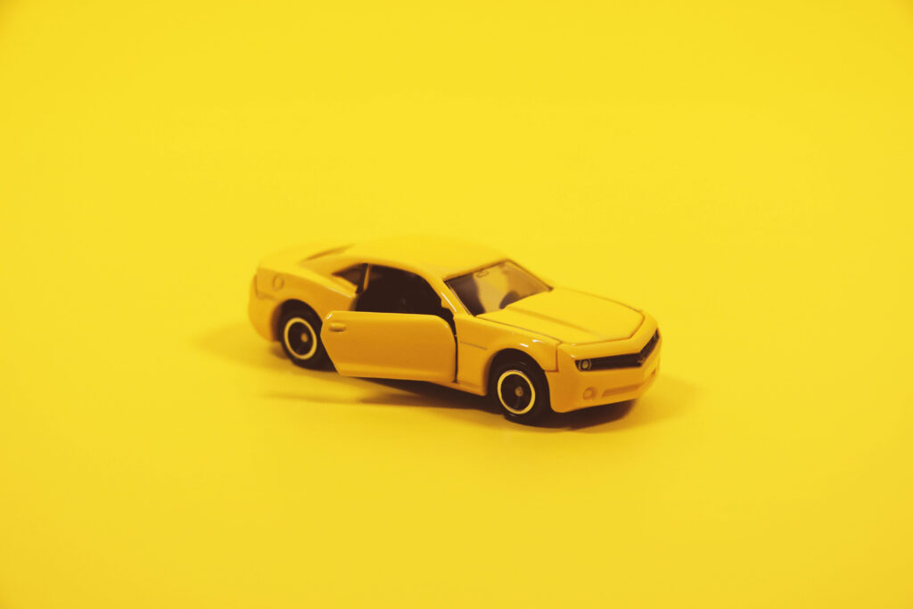 Mini Yellow Chevrolet Camaro Wallpaper on Vibrant Yellow Background