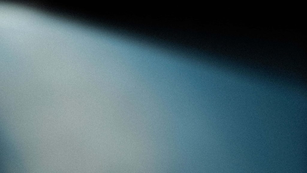 Minimalist 4K wallpaper with sleek blue gradient transitioning from black to luminous grainy blue background