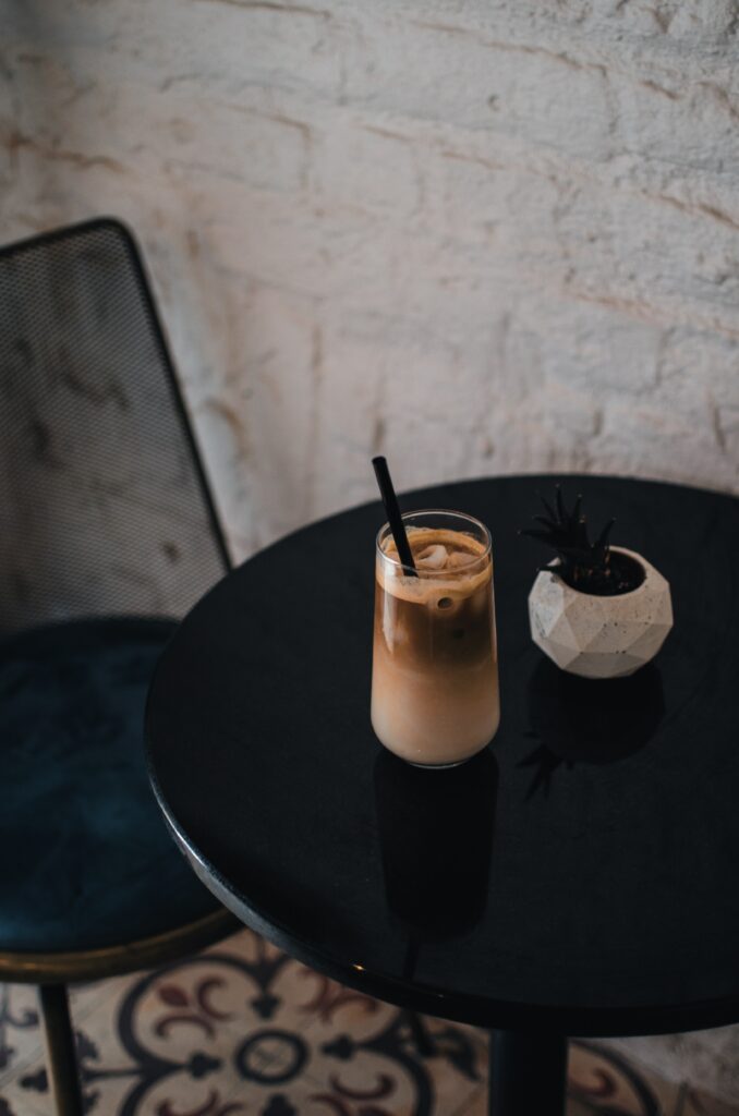 Minimalist Wallpaper: Iced Coffee & Plant on Black Table