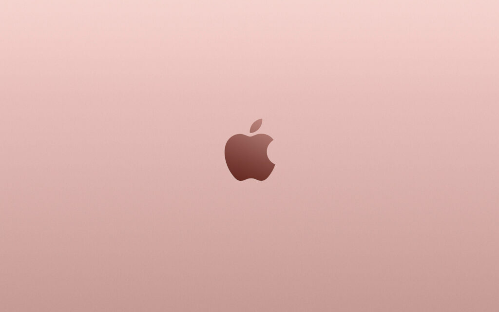 Subtle Elegance: A Sleek Apple Logo Sets the Stage Against a Soft Pink Backdrop in this MacBook Pro Aesthetic Wallpaper
