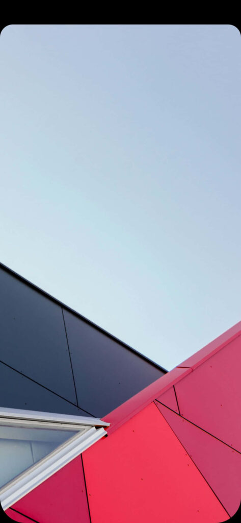 Minimalist Architectural Wallpaper: Red & Black Structures Against Sky