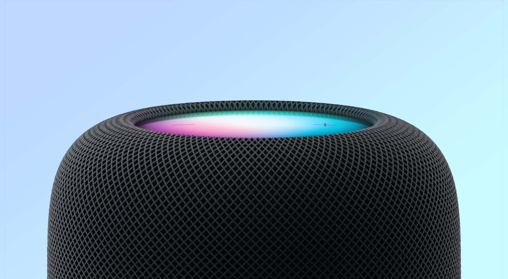 Close-up of sleek black Apple HomePod with glowing multicolor touch surface on blue background Wallpaper