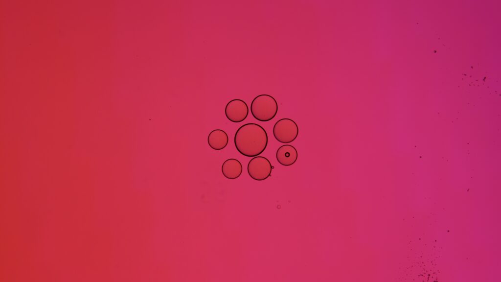 Minimalist Black Bubbles on Vibrant Pink Wallpaper Background