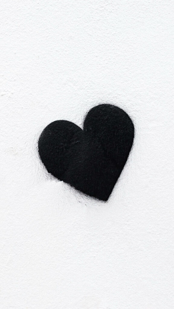 Minimalist Black Heart Wallpaper on Textured White Background