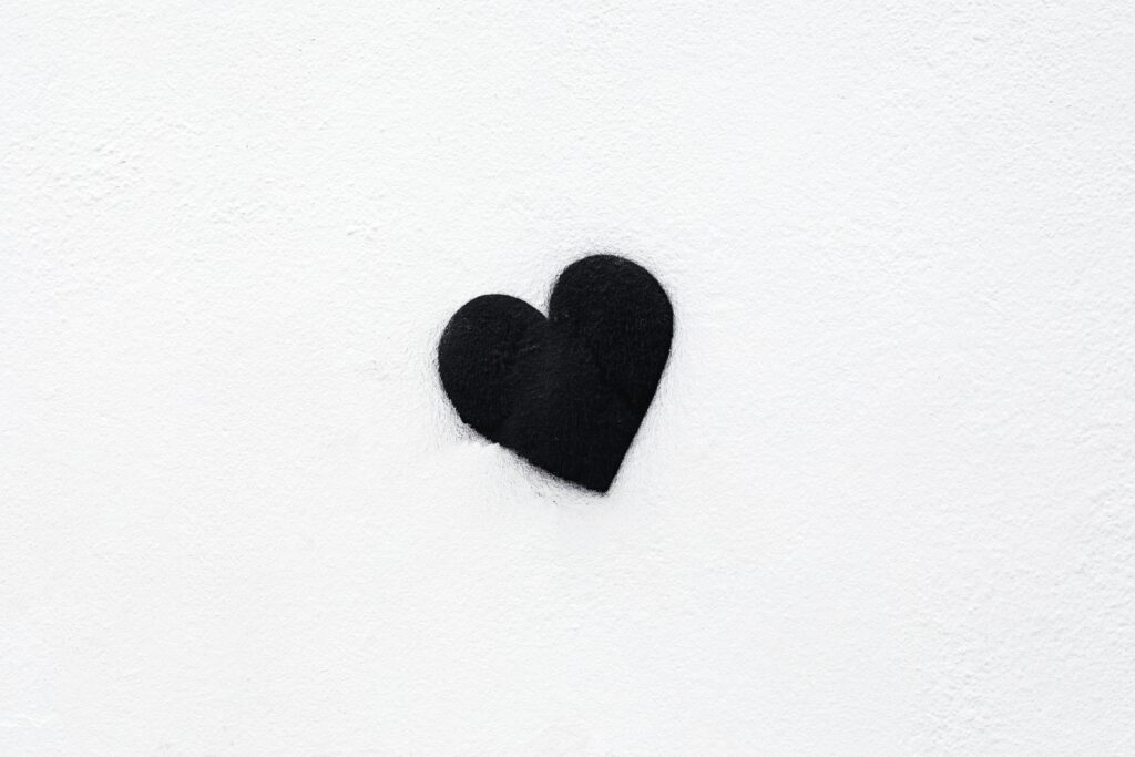 Minimalist Black Heart Wallpaper on White Background - Striking Contrast