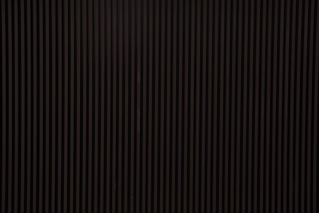 Minimalist wallpaper with sleek black vertical stripes creating a modern textured background