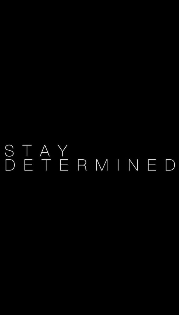 Minimalist Black Wallpaper: 'Stay Determined' Bold Reminder