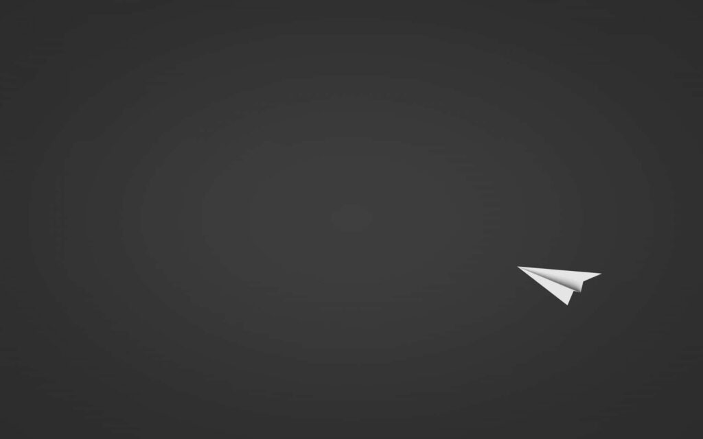 Minimalist Black Wallpaper with White Paper Airplane for Professionals