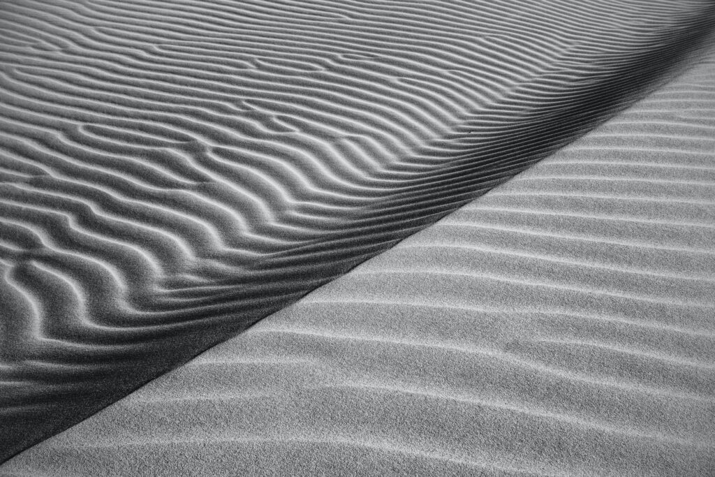 Black and white desert dunes wallpaper with rippled sand waves minimalist serene landscape