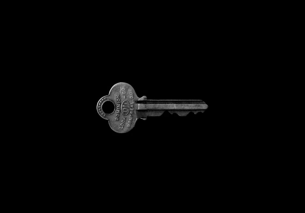 Minimalist Black and White Key Wallpaper on Dark Background