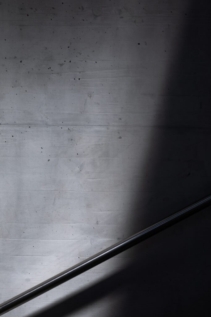 Minimalist Black and White Wallpaper with Textured Concrete and Railing
