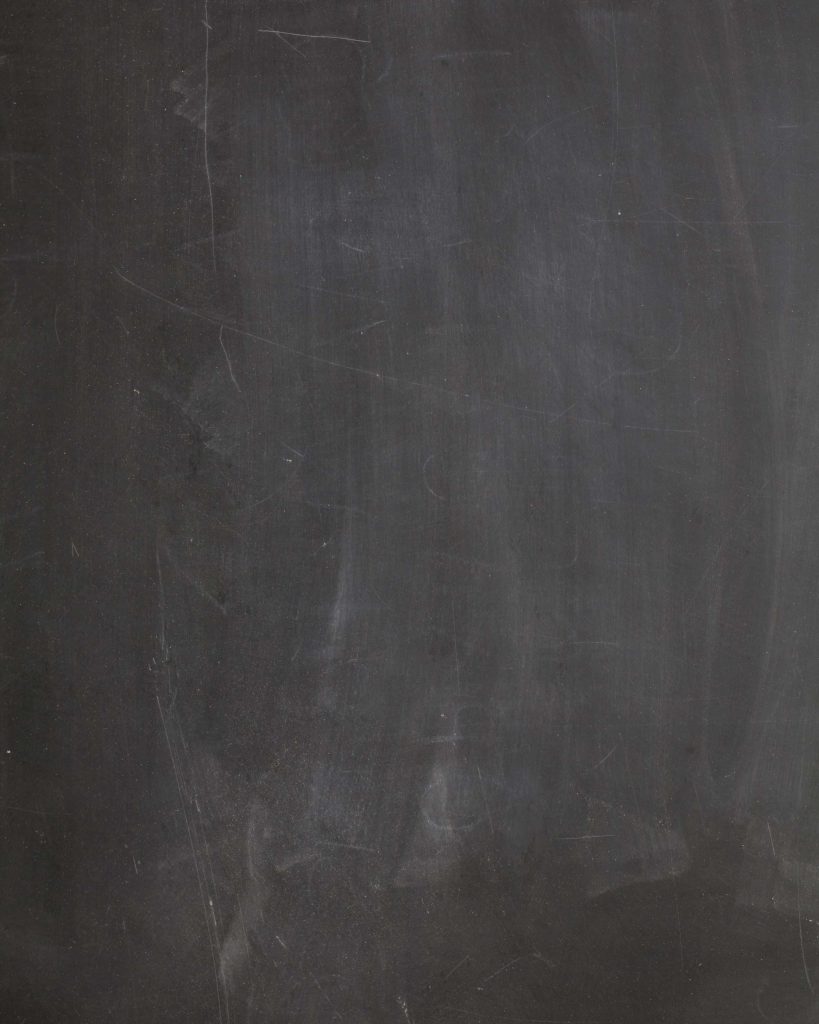 Minimalist blackboard wallpaper with faded chalk marks and scratches for creative digital workspace