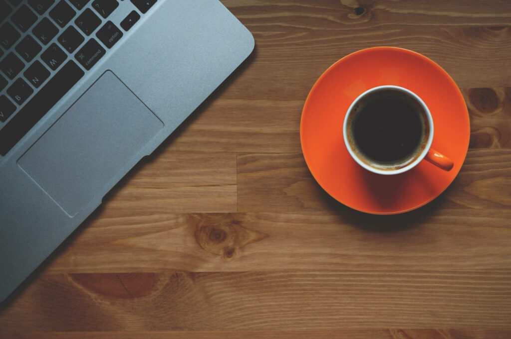 Minimalist Blogging Workspace with Sleek Laptop & Coffee Cup Wallpaper