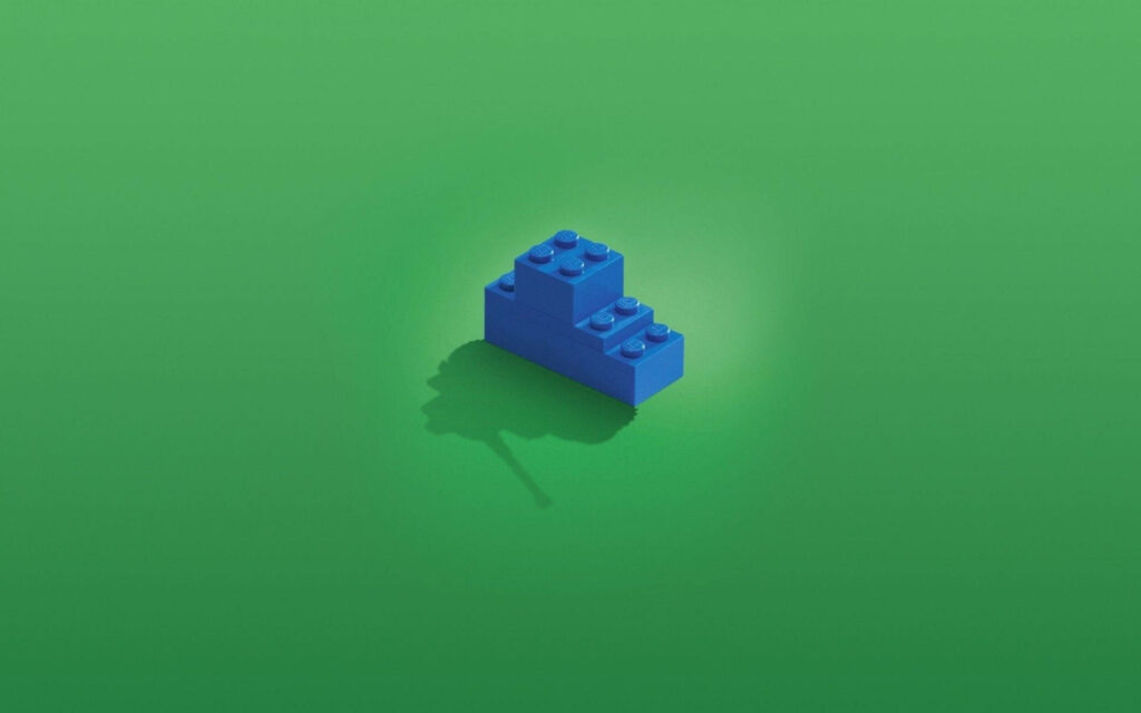 Blue LEGO brick centered on smooth green background minimalist wallpaper design background