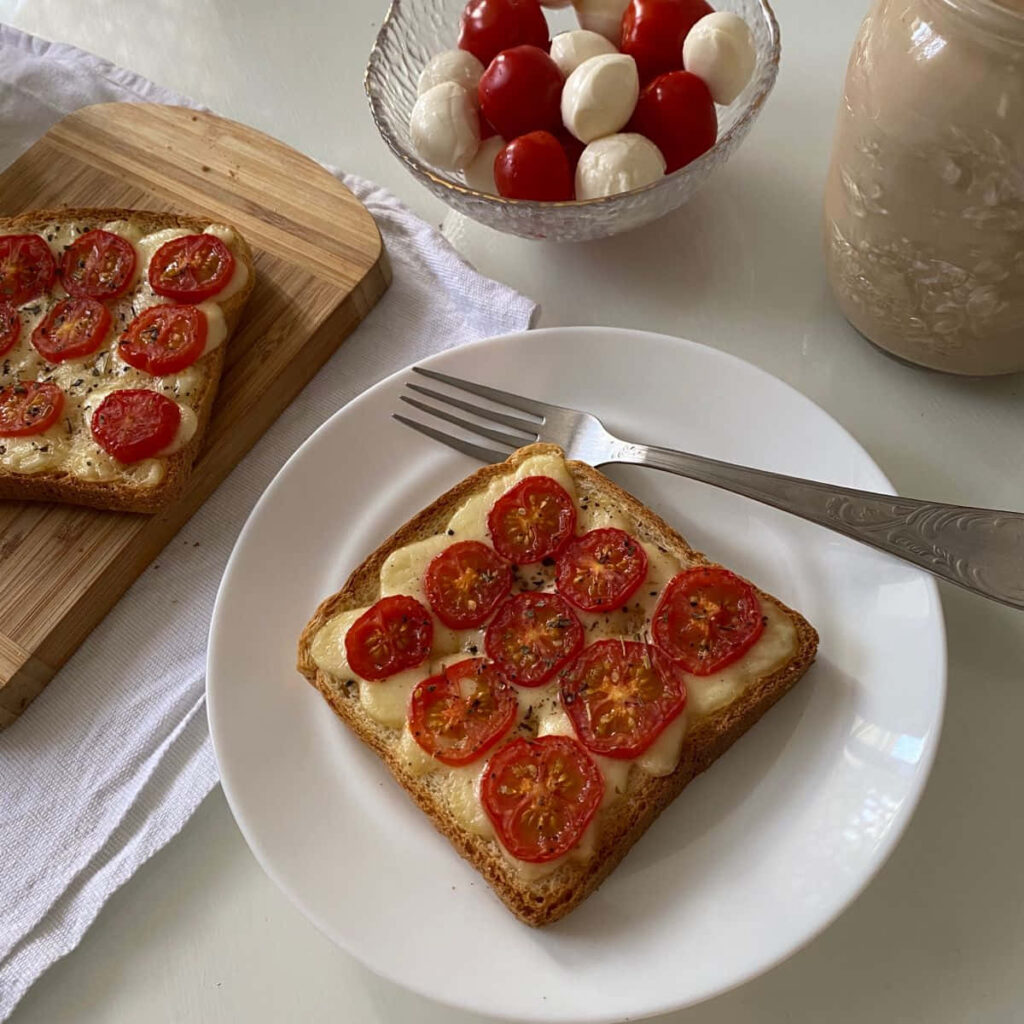 Minimalist Breakfast: Toast with Mozzarella & Tomatoes on Bright Table Wallpaper
