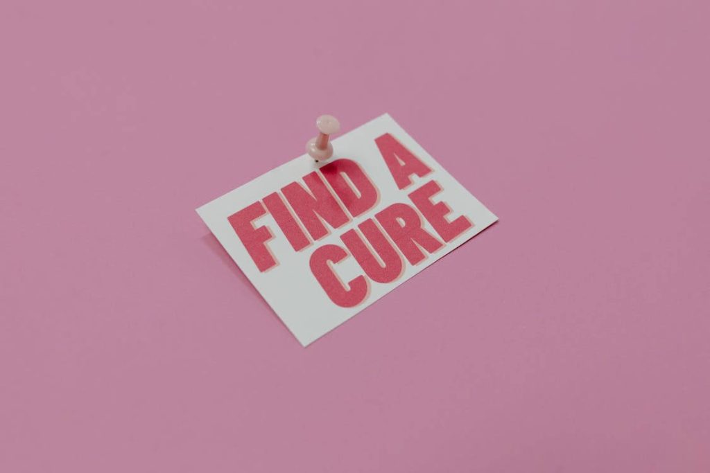 Minimalist Breast Cancer Awareness wallpaper with Find A Cure note on soft pink background