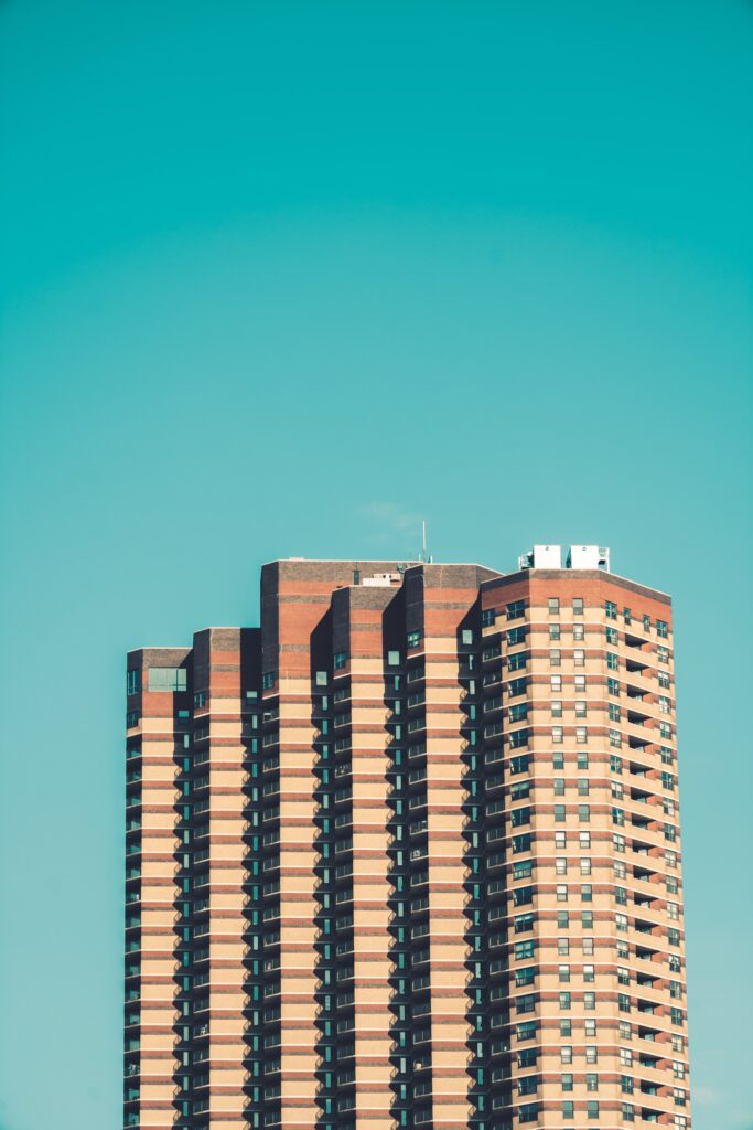 Minimalist Brick High-Rise Wallpaper Against Turquoise Sky