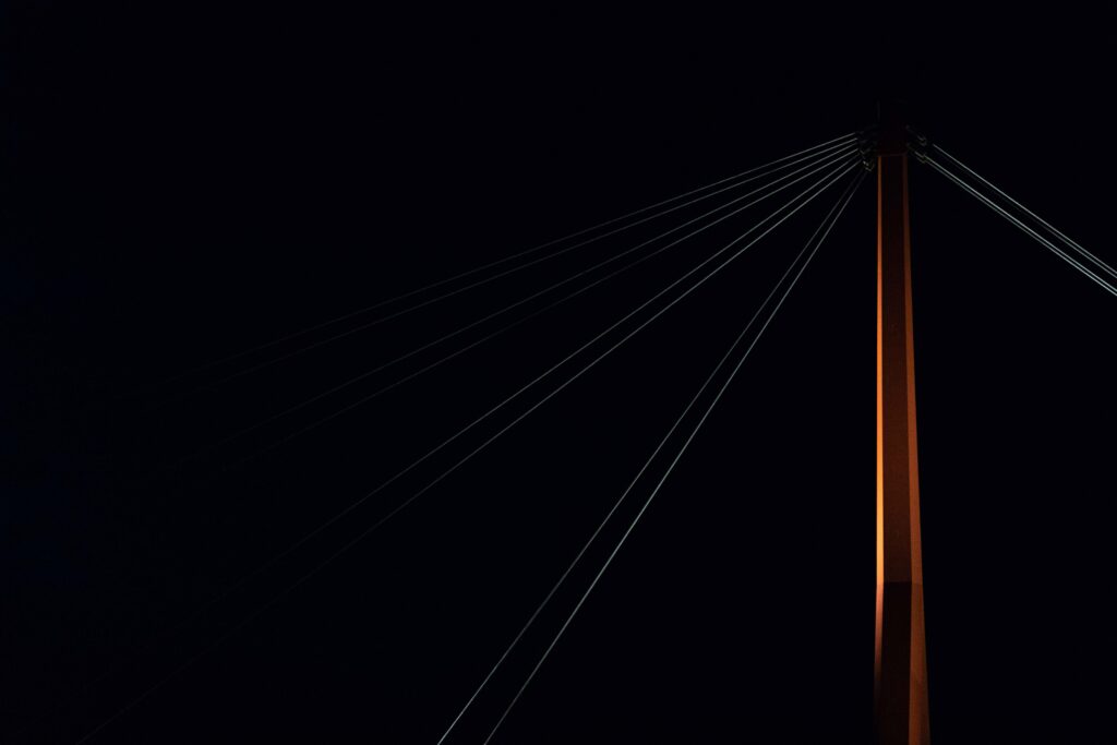 Minimalist Bridge Support Wallpaper: Dramatic Black Backdrop
