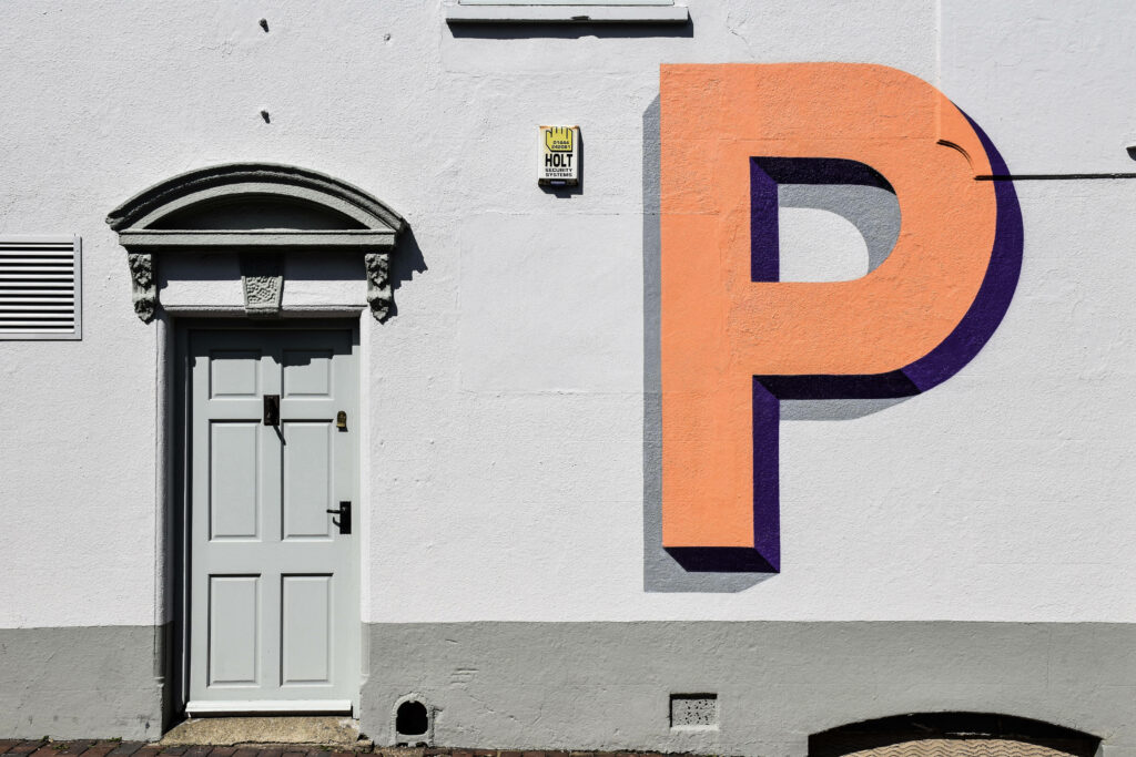 Minimalist Building Facade with Bold Orange Letter P - Elegant Design Wallpaper