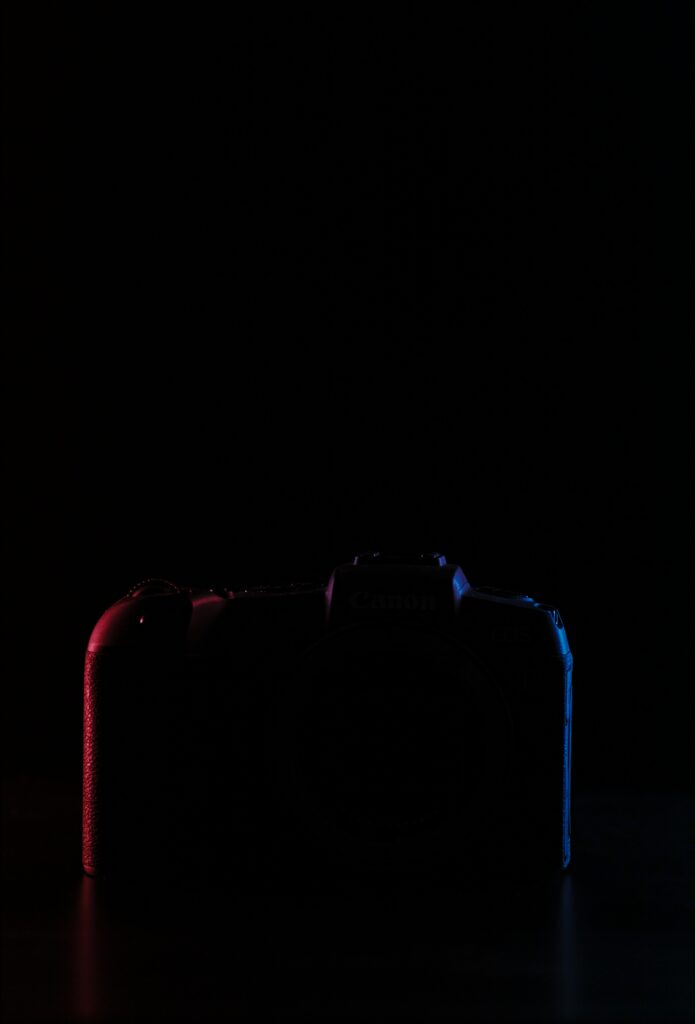 Minimalist Camera Silhouette Wallpaper with Red & Blue Lighting