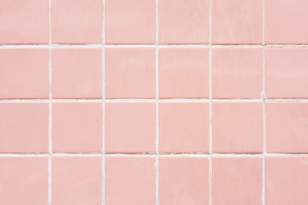 Glossy blush pink ceramic tiles grid with white grout minimalist wallpaper background seamless