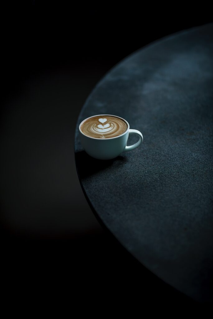 Minimalist Coffee Wallpaper: Latte Art on Dark Textured Table