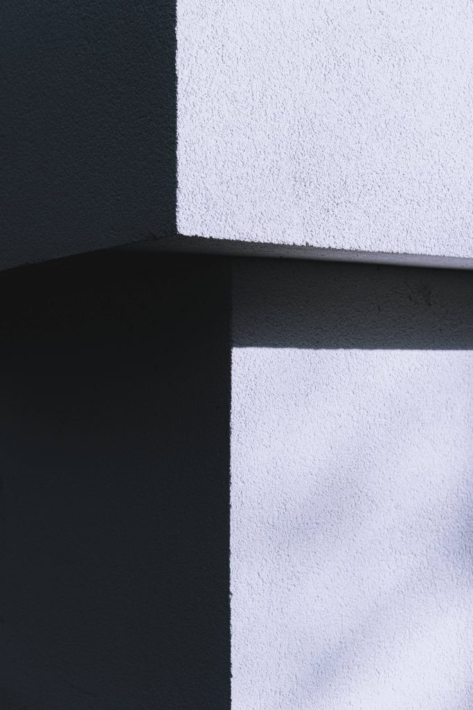 Minimalist concrete wallpaper with sharp black and white modern architectural corner texture
