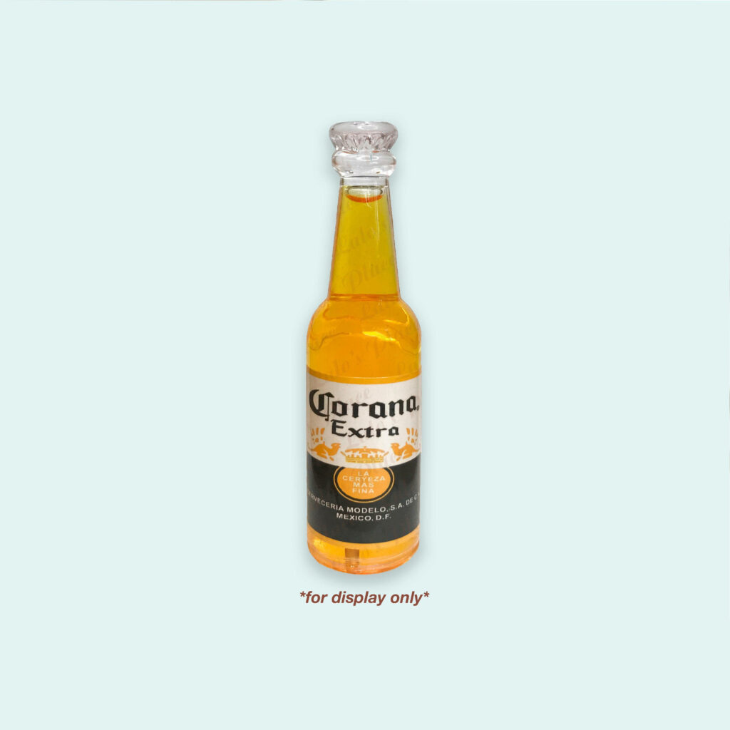Minimalist Corona Extra beer bottle on pale background with vivid golden beer and bold label Wallpaper