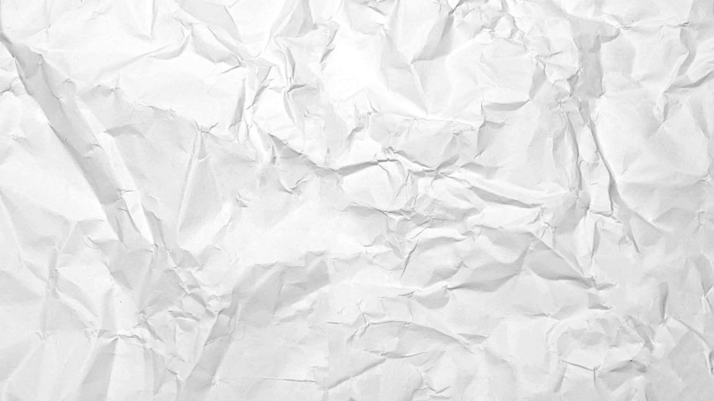 Crumpled white paper with detailed creases and soft shadows minimalist abstract background Wallpaper