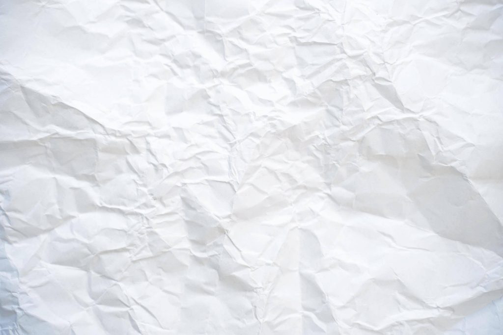 Minimalist white crumpled paper texture with dynamic light and shadow for desktop wallpaper