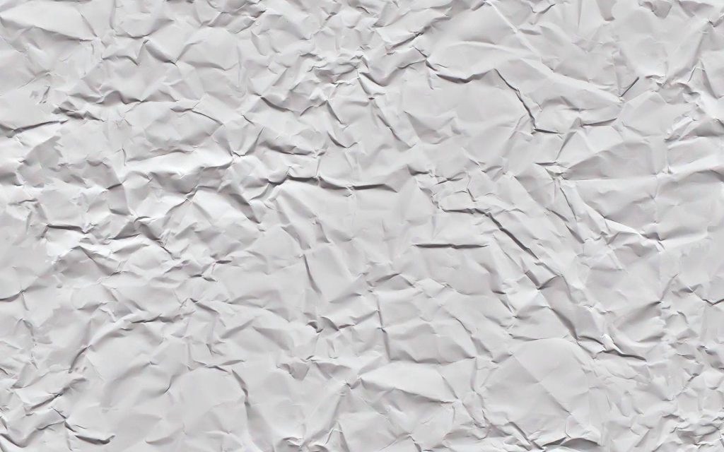 Minimalist crumpled white paper texture wallpaper with intricate folds and soft shadows background