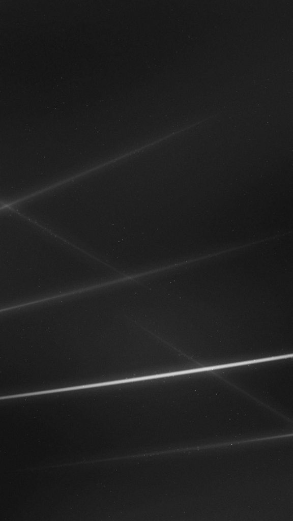 Minimalist dark mobile wallpaper with high-speed light streaks on textured black background