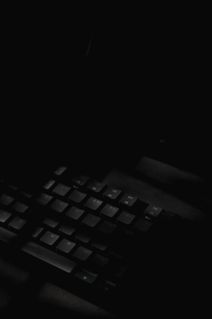 Minimalist Dark Wallpaper: Sleek Black Keyboard with Subtle Lighting