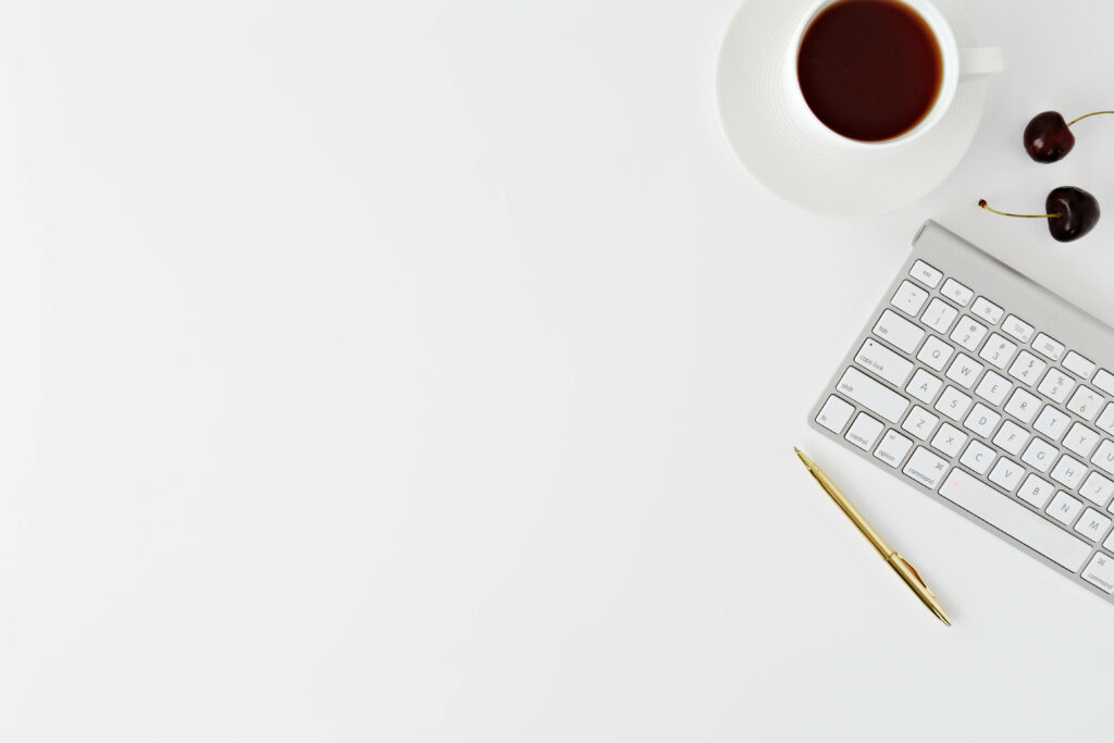 Minimalist Desk Wallpaper: White Background with Gold Pen & Coffee