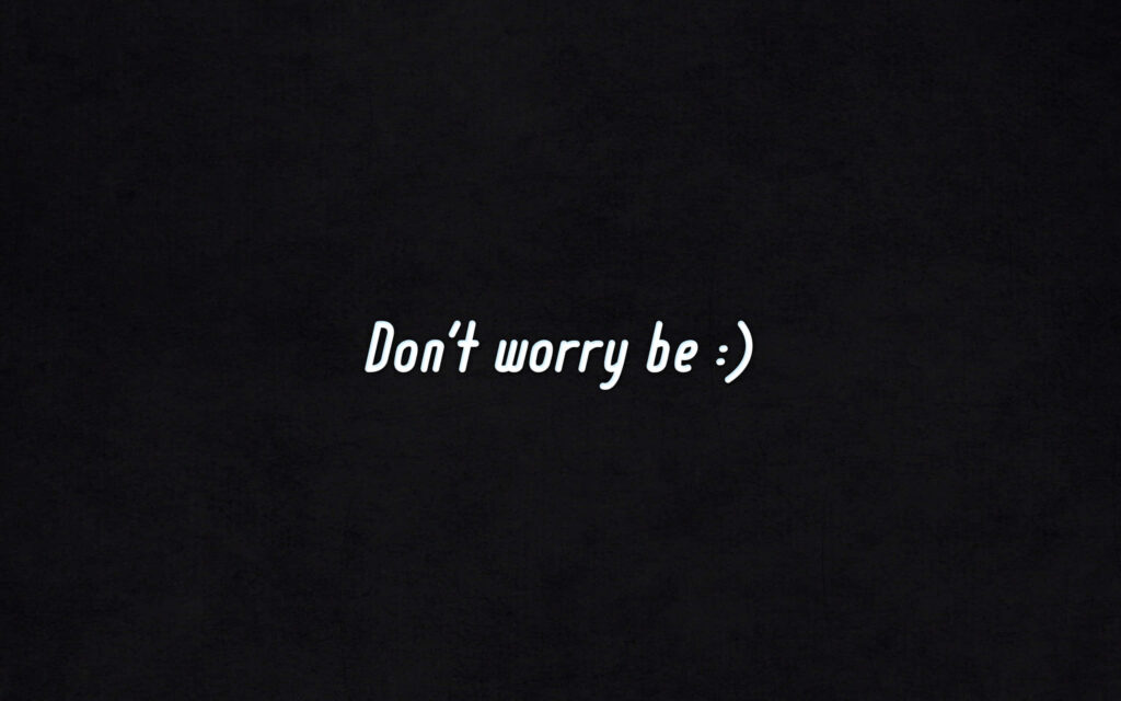 Minimalist black wallpaper with white motivational text Dont worry be smiling face for desktop