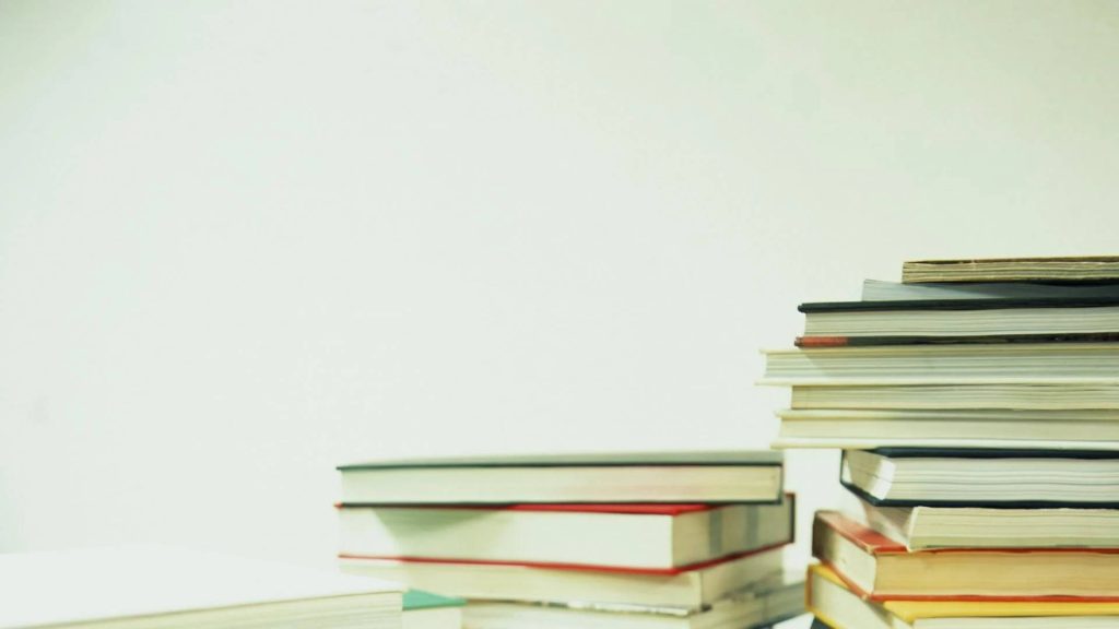 Minimalist education wallpaper with two book stacks on bright white background for study room