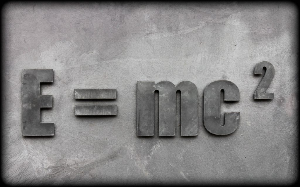 3D metallic E=mc² equation on textured concrete wall minimalist physics wallpaper background