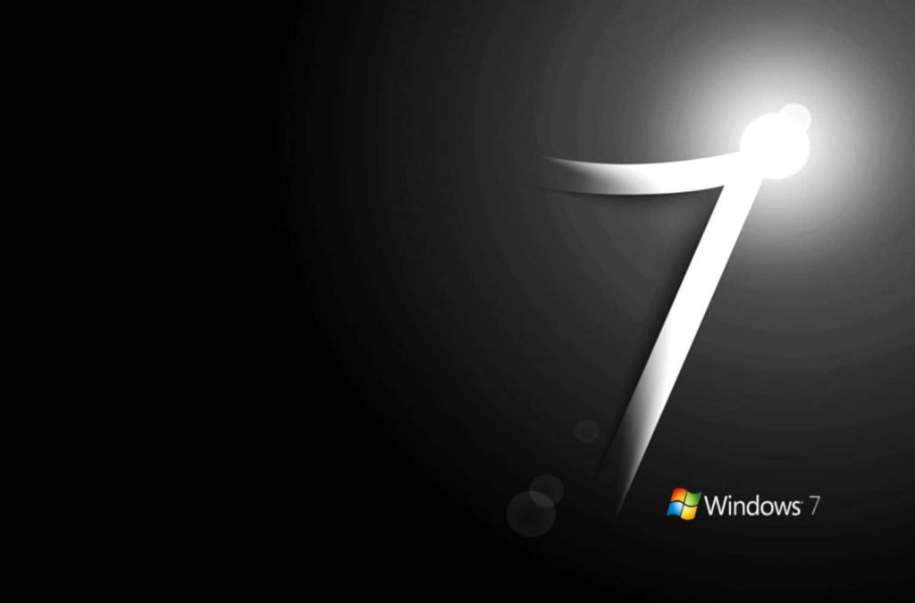Sleek glowing number seven with multi-colored Windows 7 logo on dark gradient wallpaper