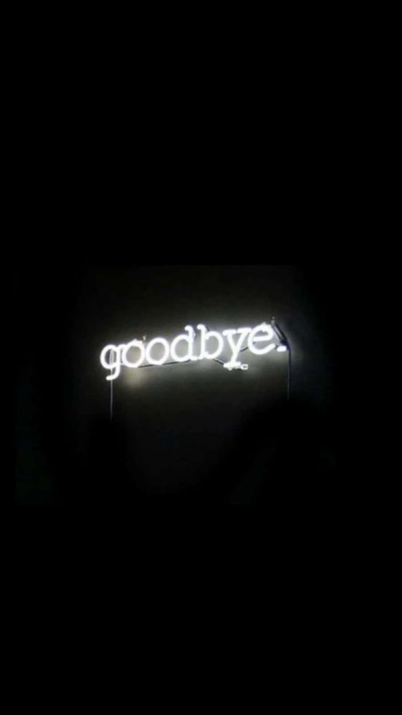 Minimalist glowing goodbye neon sign in white cursive on black moody aesthetic background wallpaper