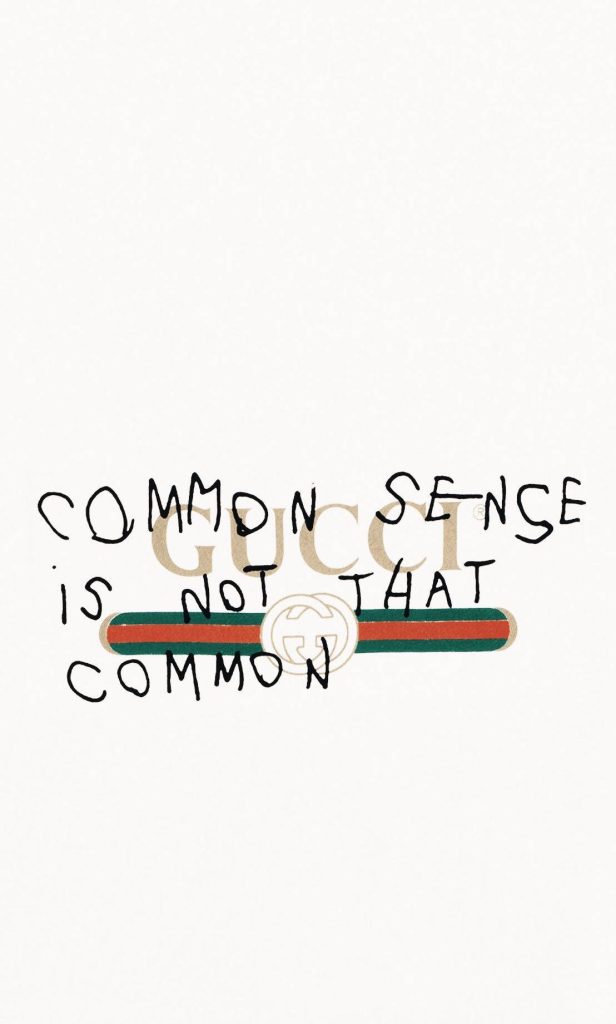Minimalist Gucci wallpaper with Common Sense quote handwritten on white background and Gucci logo