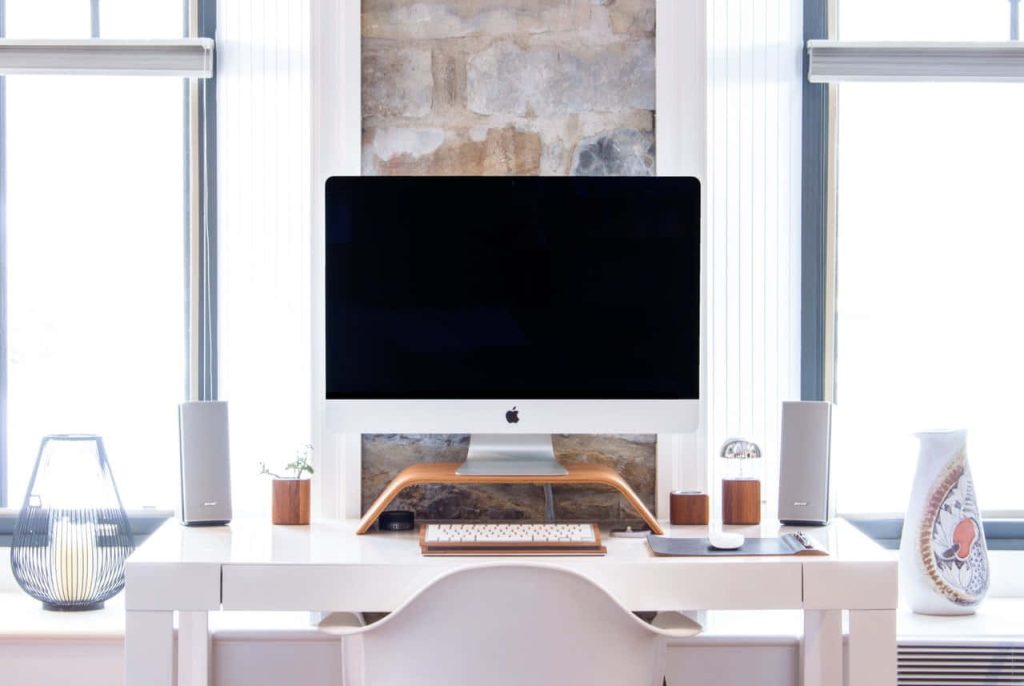 Minimalist home office Zoom background with Apple iMac white desk brick wall modern workspace Wallpaper