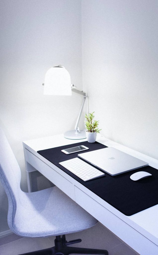 Minimalist home office iPhone wallpaper with MacBook keyboard lamp plant bright productive desk