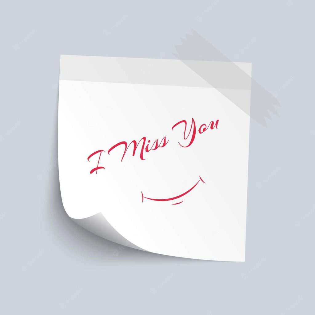White sticky note with I Miss You in red cursive and smile icon on soft grey background wallpaper