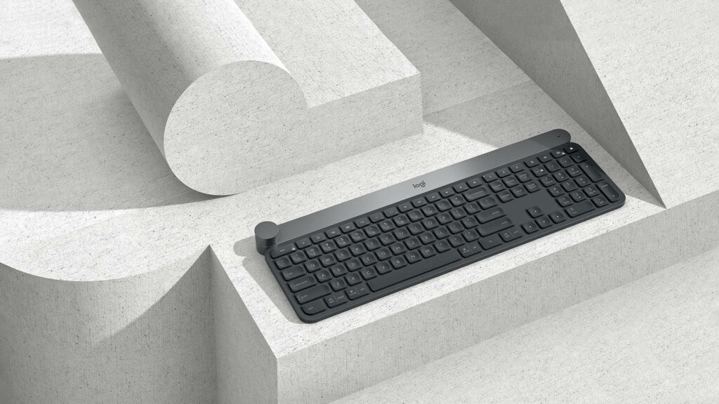 Logitech wireless keyboard on geometric concrete surface minimalist modern workspace wallpaper